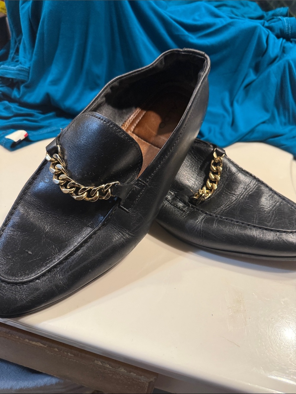 Men's Black Leather Slip-On Loafers with Gold Chain Accent. Minor abrasion